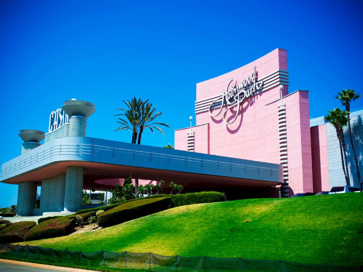 The image shows a brightly colored, retro-styled building with a large sign reading 